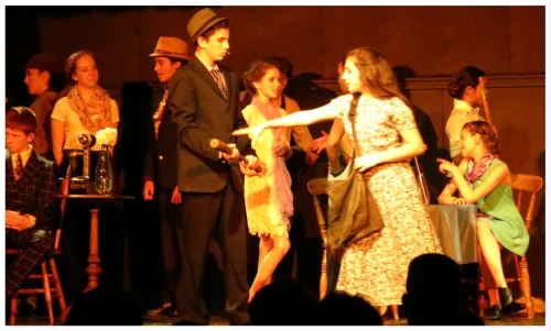 (Image: Annie Reaches to Retrieve her Baseball Bat
 from Bugsy at the Speakeasy)