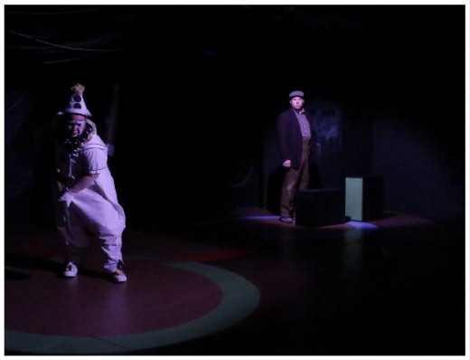 (Image: A Lone Clown digs a Grave while
 a Citizen watches from Afar)