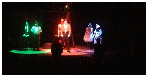 (Image: Three Groups of Circus People, Each
 in a Circle under Different-Coloured Light)