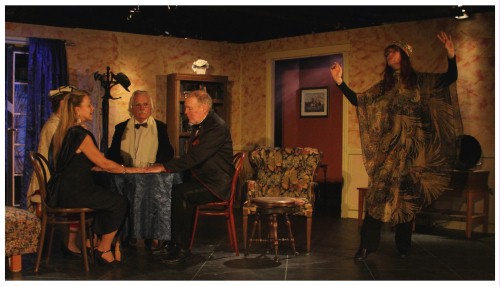 (Image: The Medium Dances while Guests
  Hold Hands at the Seance Table.)