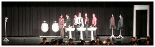 (Image: Executives Stand behind FInch at a set of Three Washroom
Sinks)