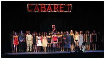 (Image: Sally is Hoisted above the Crowd.)