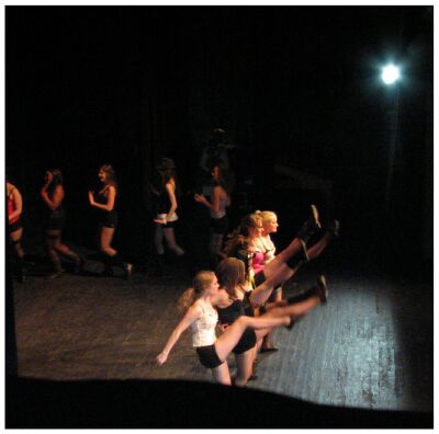 (Image: The Dancers Kick their Feet above their Heads)