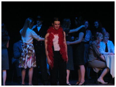 (Image: A closeup of the MC wearing a red boa.)