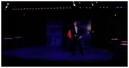 (Image: The MC Flourishes in Front of a Chair)