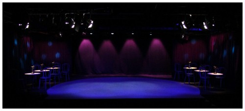 (Image: A Wide-Angle View of the Kit Kat Klub in Blue,
   Pink and Turquoise Lighting)