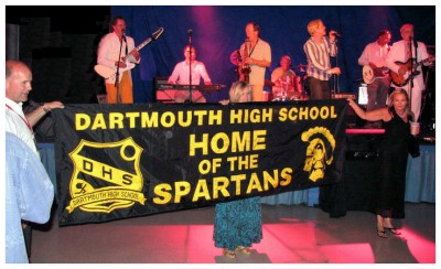 (Image: A DHS Banner is Displayed in front of the
  `Action Figures' Band)