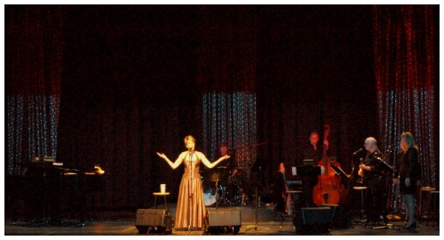 (Image: `Patsy' is Highlighted in White as her
 Band Performs around Her)