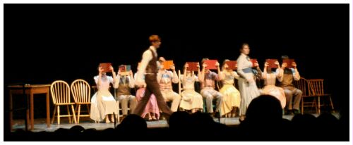 (Image: Library Patrons Hide their Faces
with Books while the Music Man pursues the Librarian)
