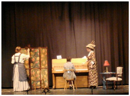 (Image: A Young Girl Plays the Piano while
her Mother and a Friend Listen)