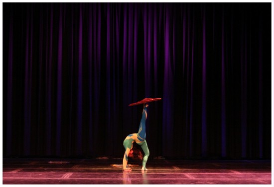(Image: A Contortionist Balances a Parasol)