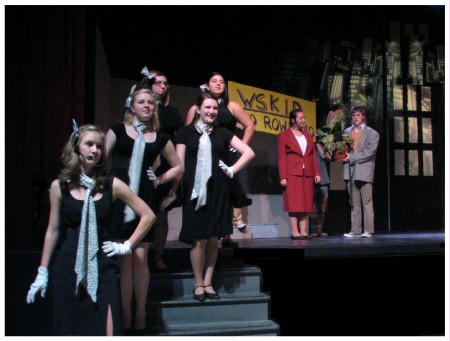 (Image: Seymore is Interviewed for a Radio Program while
 the Chorus on Foreground Steps Punctuates the Scene)