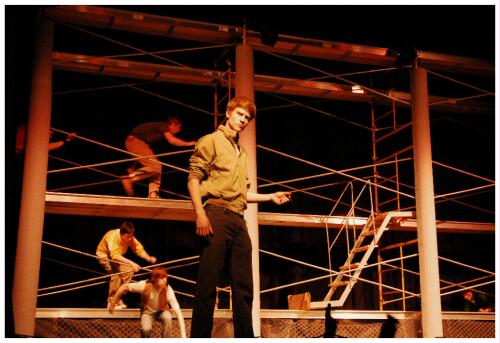 (Image: Closeup of a Dancer Snapping his Fingers
 with others in the Background)