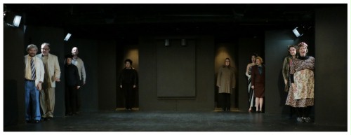 (Image: The Cast Peaks out from Various Openings
   in the Set as They Relate the Story through Song)