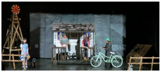 (Image: Miss Gulch Complains to Dorthy's
 Parents while Dorthy and Toto Look On)